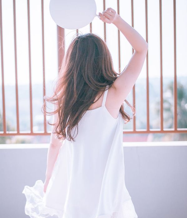 Woman feeling energized and happy in a bright, open space.